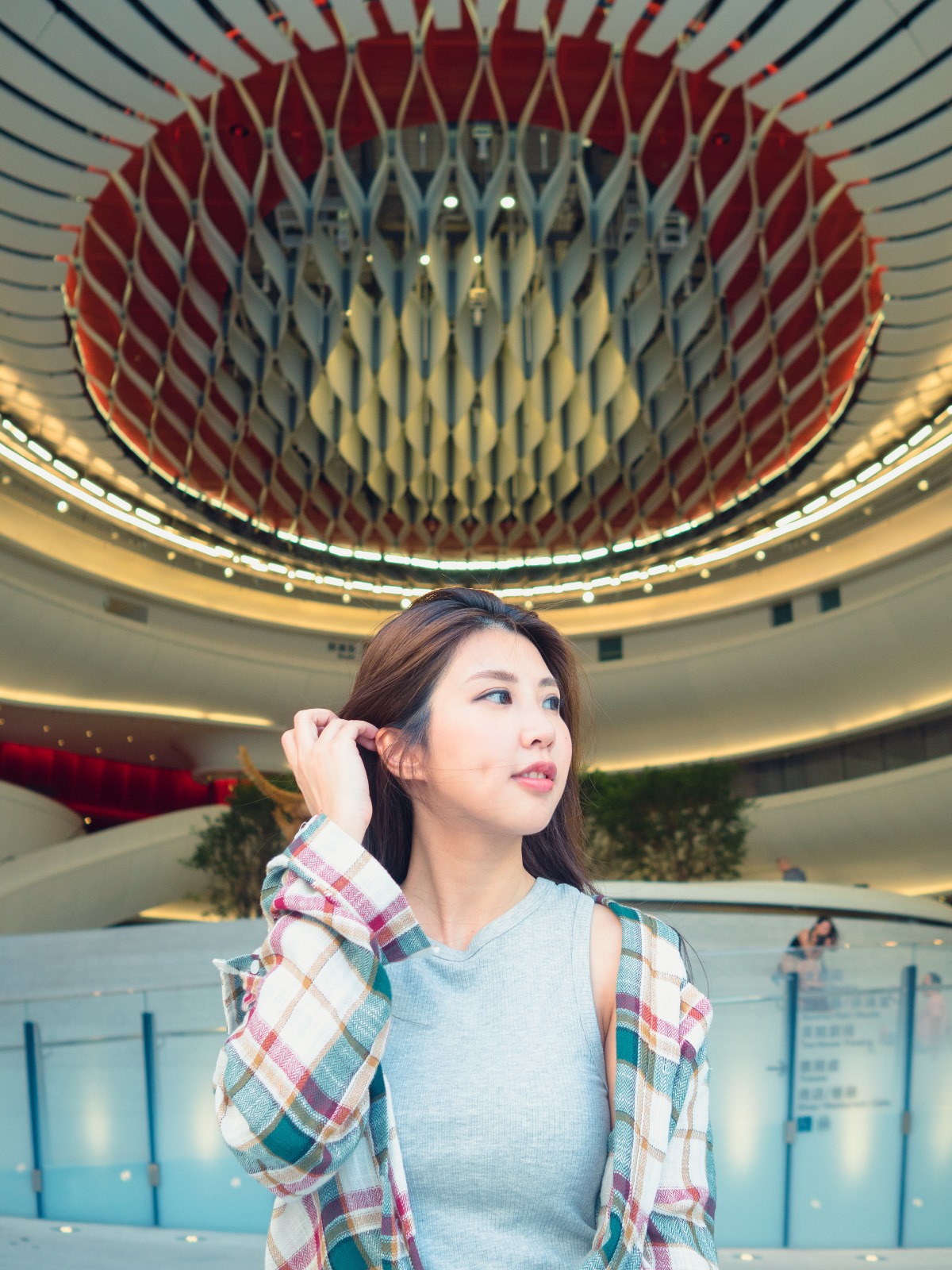 A fashionable women with long hair posing indoors.